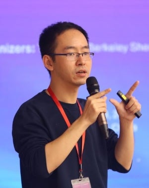 Yuxin Chen holding a microphone